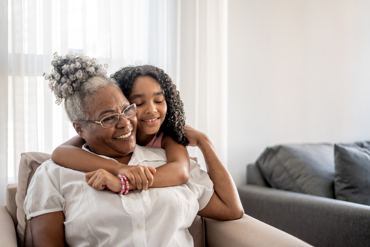 Elderly woman hugging her grandchild